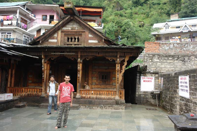 Vashishth Temple in the town of Manu-Dev (Manali), Himachal Pradesh : Posted by VJ SHARMA at www.travellingcamera.com : Vashishth Temple is near Manali which is famous for hot water springs and sand-stone temples on river bank of BEAS... Here are few few photographs of  the place with some more details....Here is main temple @ Vashishth.. There are two separate hot-water springs on the right side... These two pools of hot water are covered and meant for men/women separately.. People take bath before darshans inside the temple...Here is another temple near the main one ....Temple is situated at the suburbs of Manali which have Hot-Water Springs having special significance for their medicinal value...The gushing waters of the hot brooks are excellent ailments for skin diseases.... Large number of people come here to have a dip in these hot streams.... The authorities have arranged separate bathing provisions for men and women....Wooden Entry Gate for Vashishth Temple with amazing carving.... These stone temples show excellent and exquisite carvings on woods....There are some very good eating outs around this temple... We spent some time at a restaurant on first floor having complete view to the market and streets there... During this, we observed that many foreigners come there for many months to learn Yoga, Meditation etc... There are lot many Yoga and Mediation centers around the Temple...There is another small temple in market @ Vashishth, Manali, Himachal Pradesh....