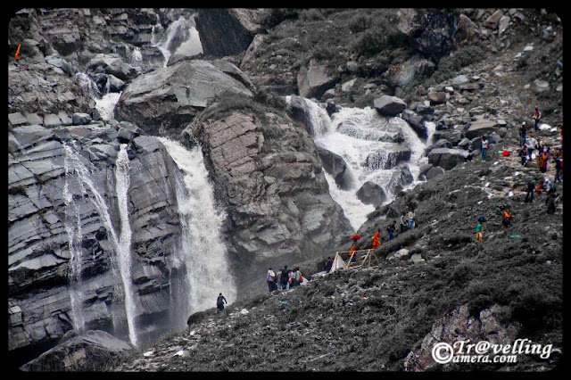 Waterfalls on the way to Mani Mahesh Lake : Posted by Vishal Sharma on www.travellingcamera.com : A long trek through Pir Panjal mountain range of Himalyas : PART-1 :  Himachal Pradesh is home to many historical and religious sites.... and also known as State of GODs... The state boasts of several exciting pilgrimage trails leading to sacred temples... The Manimahesh Yatra is one such pilgrimage which starts from Lakshmi Narayan Temple in Chamba and ends at the Manimahesh Lake  in Bundhil valley... Here are some PHOTOGRAPHS of Waterfalls on the way to Manimahesh : MANIMAHESH YATRA 2010There are countless number of waterfalls on the way and water in all of the streams in considered very medicinal... I met a gentleman who told that some medicinal plants of Himalayas are found in this region and water is very good for skin, breathing and other things which I forgot :)The Manimahesh Lake is believed to be one of the abode of Lord Shiva as per the Hindu mythologies... Notice pilgrims in colorful dresses in this photograph and try to think about the height of this waterfall... Last time I had such huge waterfalls on Shrikhand Trek ...The pilgrims walk along the rocky path completely bare footed, singing Bhajans and praying ecstatically to Lord Shiva... After reaching Mani-Mahesh Lake they take dips in the holy water. With the termination of the Manimahesh Yatra, the devotees visit the ancient temple of Chatrari, which is located between Bharmaur and Chamba...Some of us tried to climb up these hills on with these water streams but its near to impossible to complete with these streams...The wonderful route not only attract the pilgrims but also excites the adventure lovers and tourists...Freshness flowing through heavy rocks @ Manimahesh, Chamba, Himachal Pradesh, INDIAWalking to the way of the Manimahesh Lake is a wonderful experience... One will forget the pains of the tiresome journey watching the wonderful natural scenery and fresh environment around.... However one should be physically fit to endure this journey in an altitude of 4100 meters.... The Manimahesh Yatra in Himachal Pradesh is treated as a state level fair as per the declaration of the Himachal Pradesh State Government. The Himachal tourism department has undertaken various plans and programs to promote this wonderful event... Manimahesh is well approached from Pathankot through Chamba and Bharnaur... Pathankot is nearest railway station to approach this place...  Freshness flowing through heavy rocks @ Manimahesh, Chamba, Himachal Pradesh, INDIAWalking to the way of the Manimahesh Lake is a wonderful experience... One will forget the pains of the tiresome journey watching the wonderful natural scenery and fresh environment around.... However one should be physically fit to endure this journey in an altitude of 4100 meters.... 