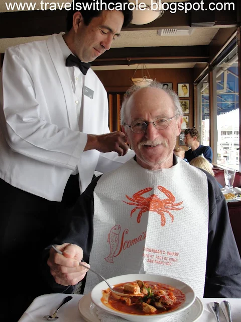 waiter ties bib on diner at Scoma's Restaurant in San Francisco, California