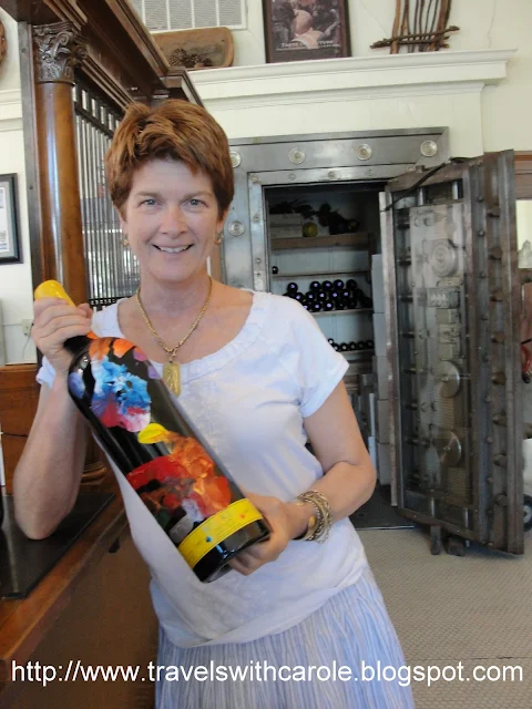 Mrs. Meeker displays a bottle of wine at Meeker Winery in Geyserville, California