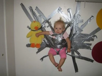 photo of a baby taped to the wall