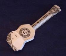 dollar bill folded in shape of ukelele