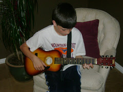 Logan playing his guitar