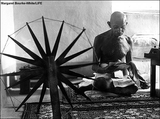 [Gandhi+reads+papers+in+front+of+his+spinning+wheel.jpg]
