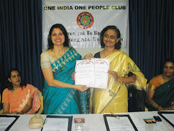 Mrs. Hegde presents the OIOP Club Membership Certificate to Mrs. Sinkar