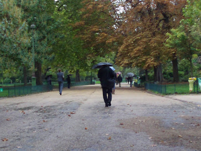 Man walking with an umbrella at Monceau Park