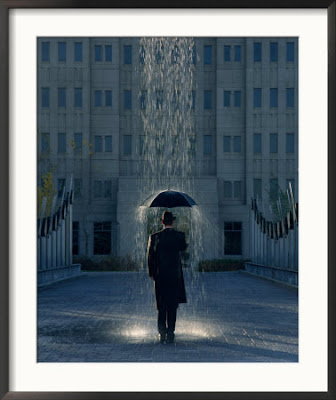 Man-with-Umbrella-Under-a-Regional-Rain-Framed-Photographic-Print-C12768824.jpg