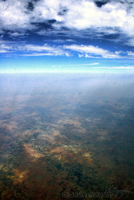 arial photography through window aircraft fine line between earth and sky