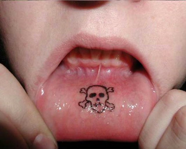 Skull and crossbones lip tattoo.