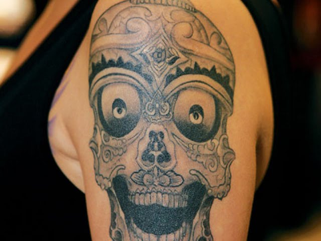 Voodoo skull shoulder tattoo