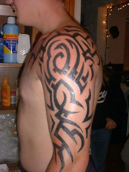Puzzled tribal arm tattoo for guys.