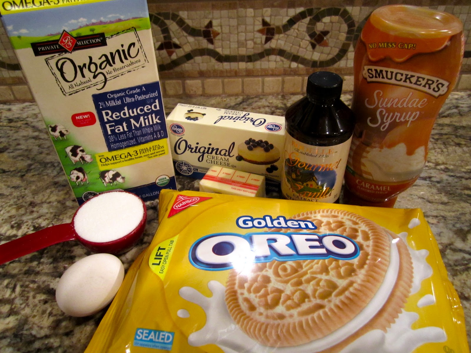 Sweet Tooth Sisters Caramel Swirled Golden Oreo Cheesecake Bars