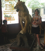 JD and Caitlin next to a stuffed lion