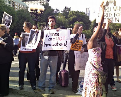 shot from first vigil with sign that says Women Are Not Incubators