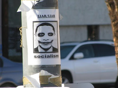 sign that says liar/liar socialism with a picture of President Obama wearing joker makeup