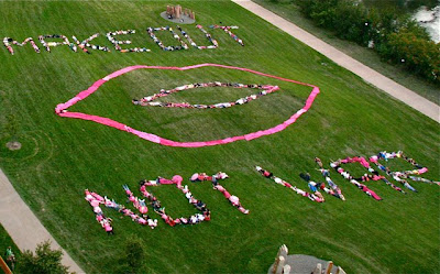 Protesters spell out Make Out not war with their bodies on grassy field