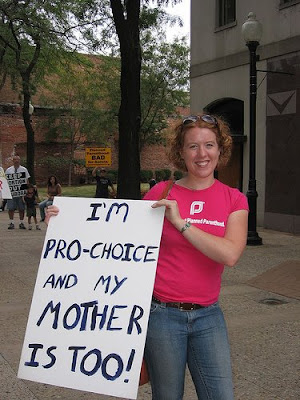 woman with sign that says I am pro choice and so is my mother