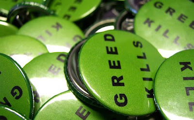 pile of buttons that say Greed Kills