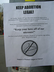 flyer defending abortion rights featuring no symbol across a coat hanger