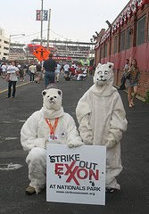 guys in polar bear suits with sign that says Strike Out Exxon