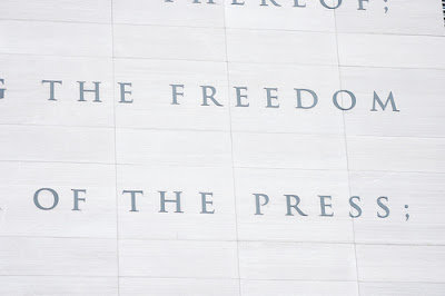 stone carving that says freedom of the press
