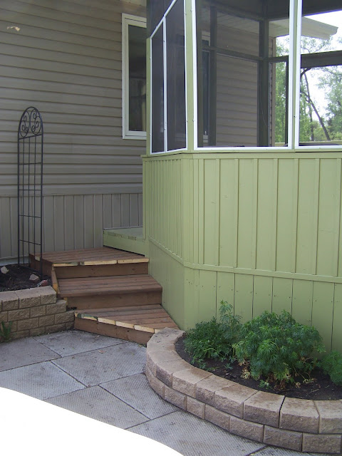 Steps from deck to patio with stacked stone planters Steps from deck to patio with stacked stone planters