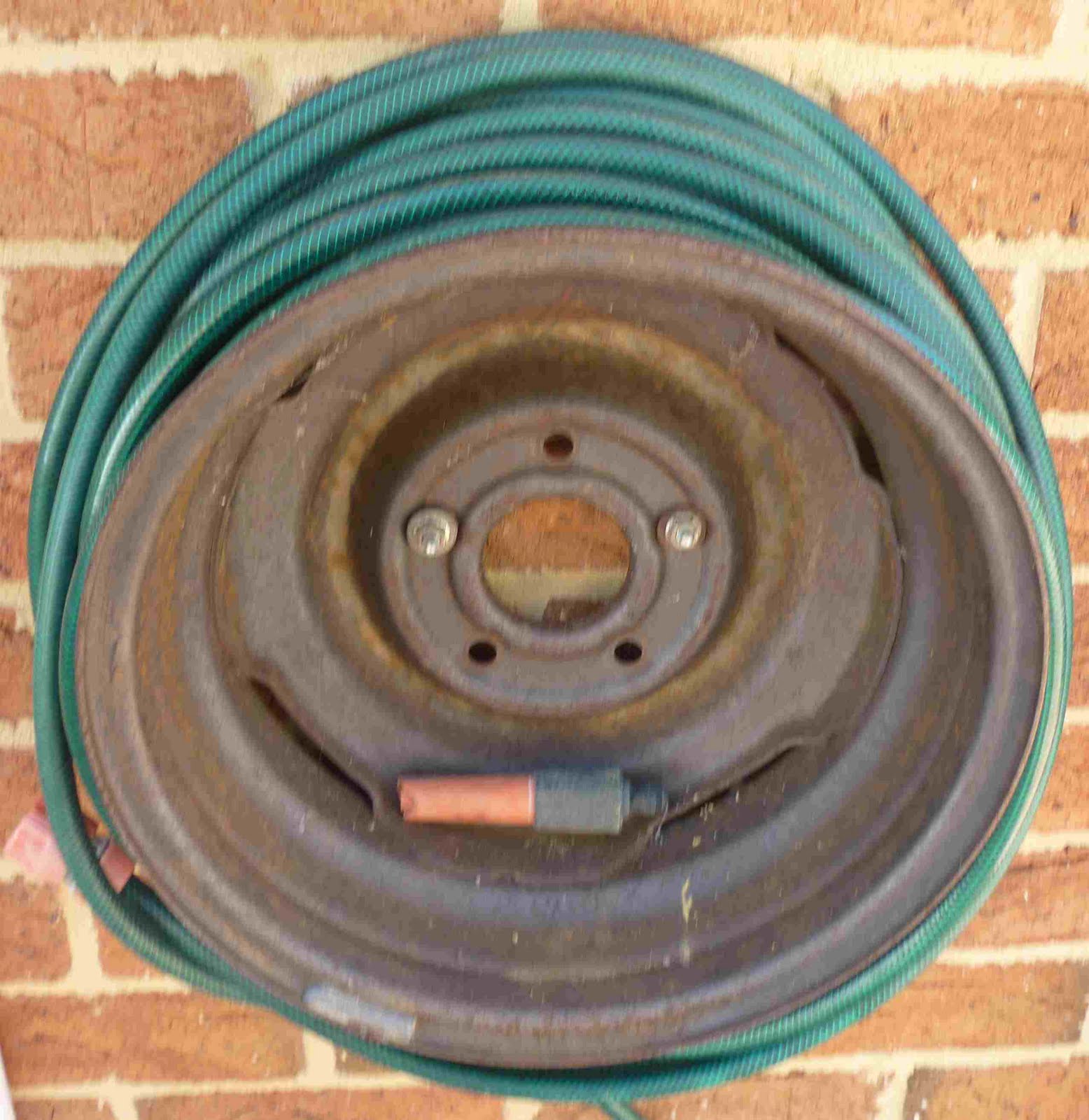 Simpleliving A Tyre Rim Makes A Great Hose Holder
