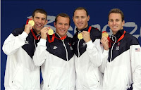 U.S. Olympic Swimmers Michael Phelps, Brendan Hansen, Jason Lezak and Aaron Peirsol Hold Up Their Gold Medals From The Men's 4x100 Medley Relay