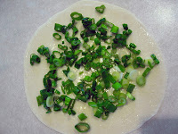 Morsels of Life - Cong You Bing (Chinese Scallion Pancakes) Step 7 - Paint the flour/oil/salt slurry on the top surface, and then put scallions on top of that.