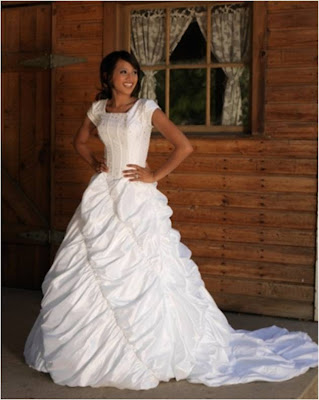 This taffeta modest wedding gown has boning in the bodice with bead 