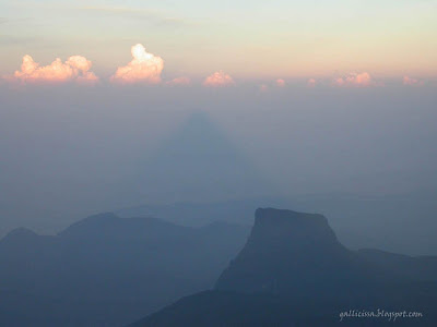 The sunrise from the summit of Adam's Peak showing the conical shadow of the Adam's Peak cast on the veil of mist on the western side for a brief moment