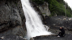 Dorothy Taking a Picture of Waterfall in Seward