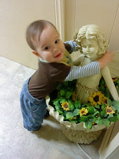 Mason hugging a fairy statue