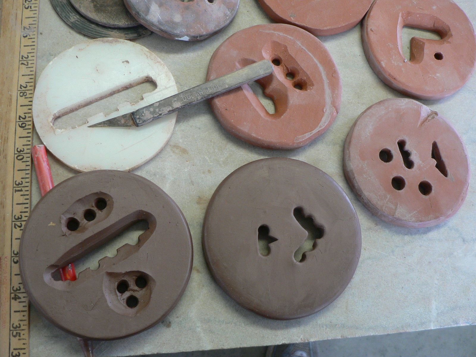 ANN TUBBS POTTERY STUDIO using clay to cut dies for the extruder