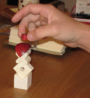 The picture doesn't show the tension on the players face and the quivering hand as he tries to place the next object in a game of Bausack