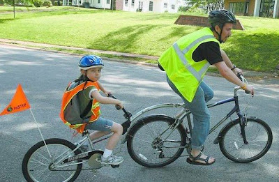 Scott Infanger picks up his daughter, Elizabeth, from Kilby School in Florence, and they bicycle home