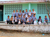 schoolchildren with their donated school supplies