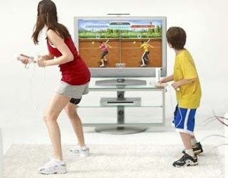 boy and girl in front of screen playing ea sports active game