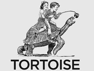 tortoise with two children riding on its back