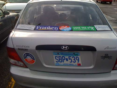 Silver car with three Obama stickers, a Franken sticker and two other stickers