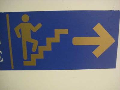 Walking figure on stairs with arms akimbo as if dancing