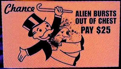 Orange Monopoly-type card with the Alien bursting out of the Uncle Moneybags' chest