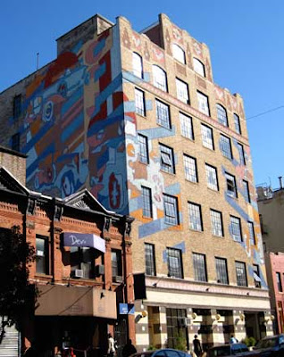 8 story building painted with a colorful car mural