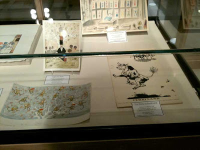 Display case with original artwork from Caps for Sale and Ferdinand