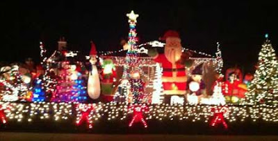 Giant inflated Santa and Christmas lights on a house