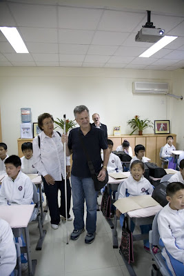 Rami Rabby with cane in classroom of blind students