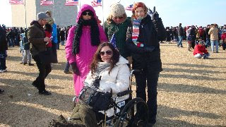 Group around person in wheelchair near crowd