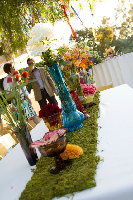 The mismatched vases and flowers were gorgeous at the wedding!