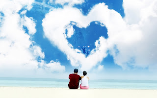 Lovers sitting on Beach Heart Shaped Clouds HD Valentines Day Wallpaper