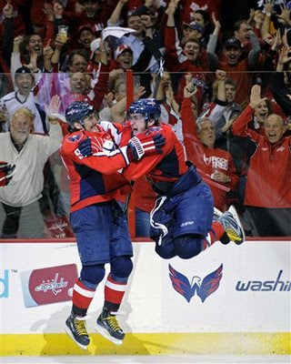 Ovechkin jumps into the arms of fellow countrymen Sergei Fedorov (91) after scoring his third goal of the game